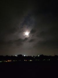 Illuminated city against sky at night