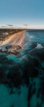 Aerial view of sea against clear sky