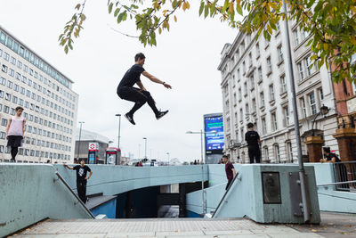 Full length of man skateboarding in city
