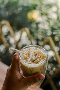 Close-up of cropped hand holding drink glass