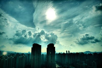 Cityscape against cloudy sky