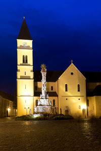 Illuminated building against sky at night