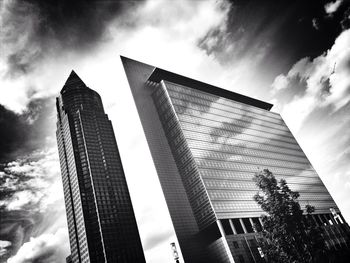 Low angle view of buildings against cloudy sky