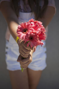 Close-up of woman holding flowers