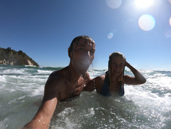 Shirtless man swimming in sea
