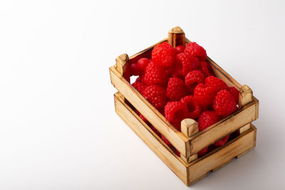 Close-up of strawberries in container against white background