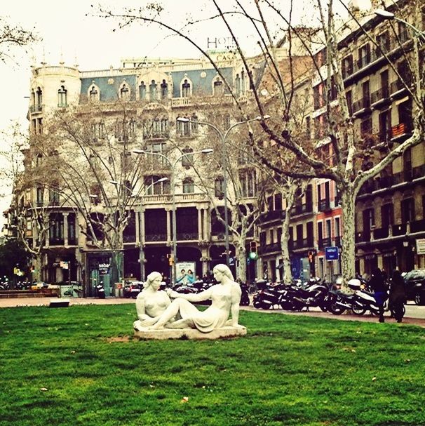 building exterior, architecture, built structure, grass, lawn, statue, sculpture, city, building, incidental people, tree, day, human representation, outdoors, facade, travel destinations, green color, fountain, history