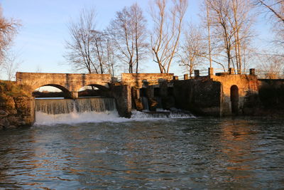 Bridge over river with buildings in background