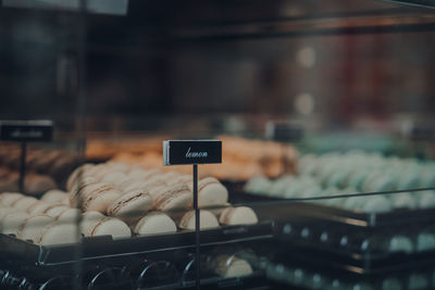 Lemon macaroons in a window display of a bakery, selective focus.