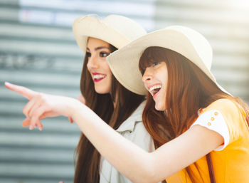 Portrait of smiling young woman wearing hat