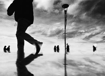 People walking on street against sky