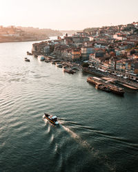 High angle view of buildings by sea against sky