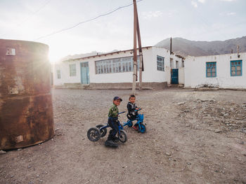 BOY RIDING MOTORCYCLE ON STREET