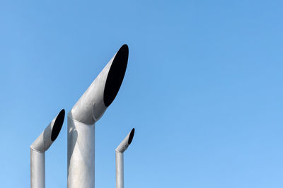 Low angle view of sculpture against clear blue sky