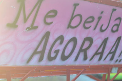 Close-up of text on pink board