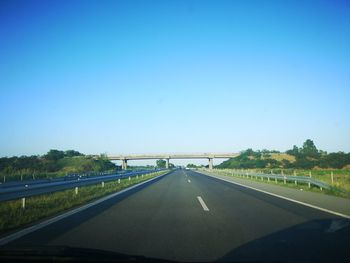 Empty road against sky seen through car windshield