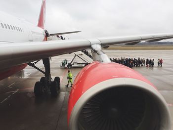 Airplane on runway against sky