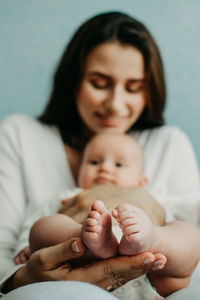 Health insurance for newborn babies. life insurance for new baby. mother holding in hands feet of