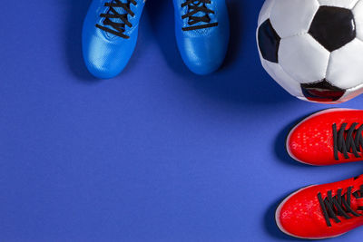 High angle view of soccer ball on blue background