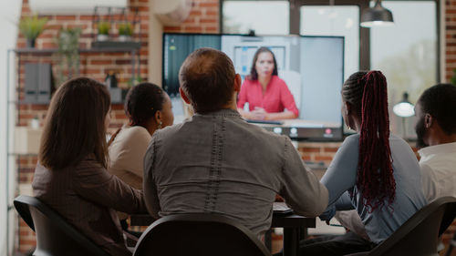 Business colleagues during video call at office