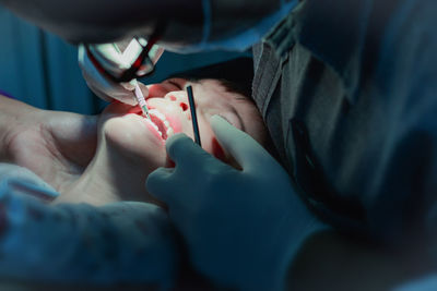 Close-up of dentist examining boy