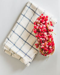 High angle view of berries on white table