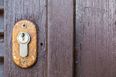 Full frame shot of old wooden door with keyhole