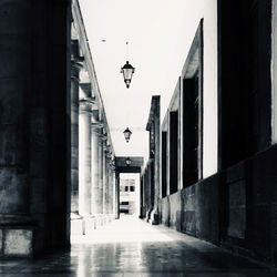 Empty street amidst buildings in city