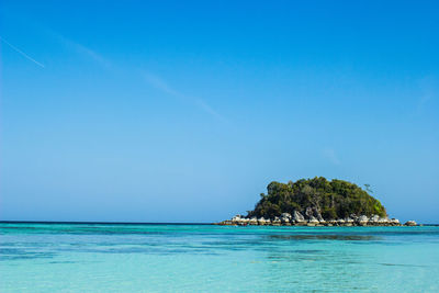 Scenic view of sea against clear blue sky