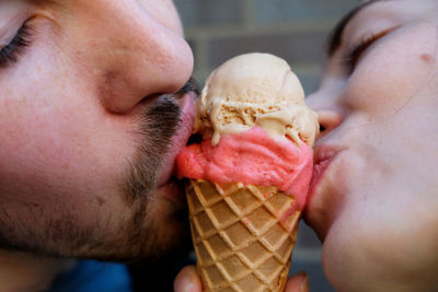 Close-up of couple sharing ice cream