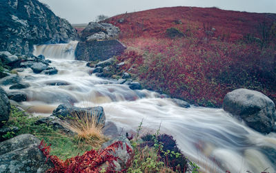 Scenic view of waterfall against sky