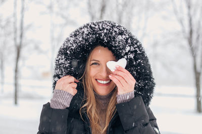 Portrait of smiling young woman in snow