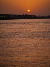 Scenic view of sea against orange sky