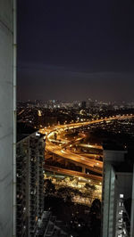 High angle view of illuminated buildings in city at night