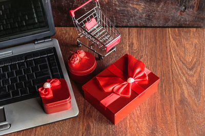 High angle view of red and laptop on table