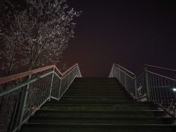 Low angle view of staircase against clear sky at night