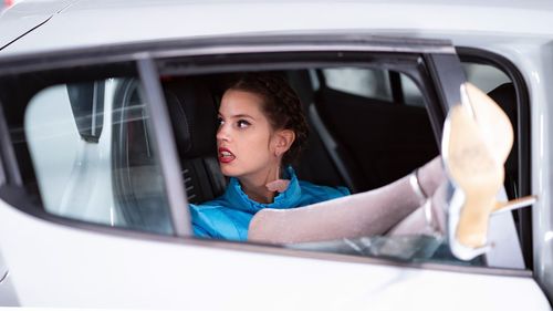 Portrait of woman sitting in car