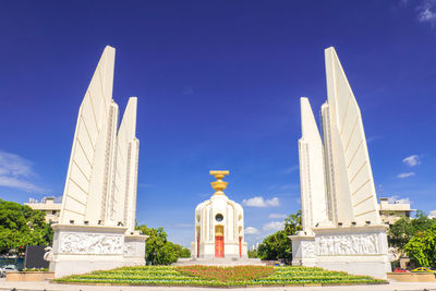 Low angle view of democracy monument against blue sky