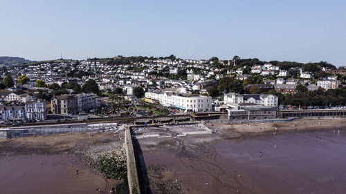 High angle view of river and buildings against clear sky