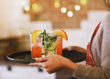 Midsection of woman holding drink