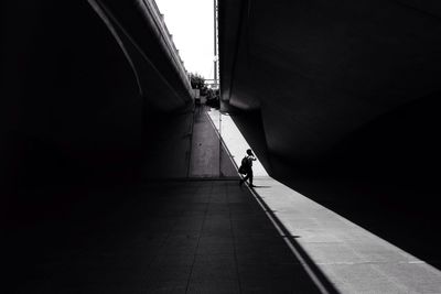 Full length of woman walking on footbridge