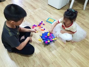 High angle view of children playing with toy
