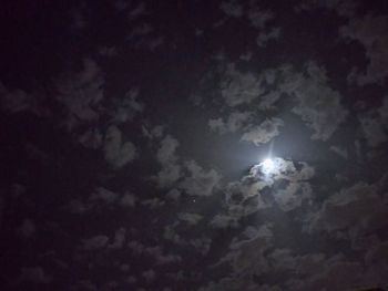 Low angle view of illuminated moon in sky