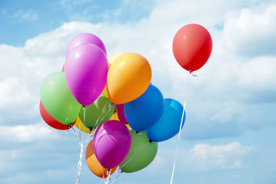 Low angle view of balloons against sky