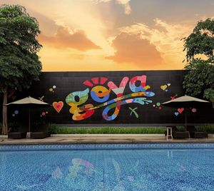 Plants by swimming pool against sky during sunset