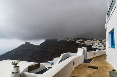 Houses against cloudy sky