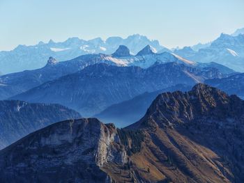 Scenic view of mountains against clear blue sky