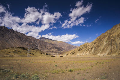 Scenic view of field and mountains against sky