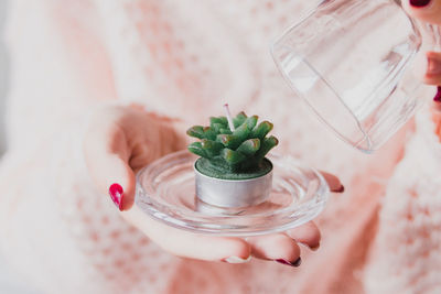 Close-up of hand holding candle