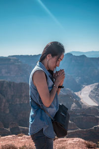 Man standing on mountain against sky